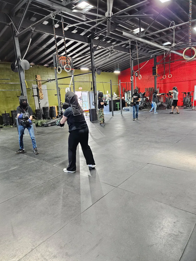 Pairs of students completing longsword drills.