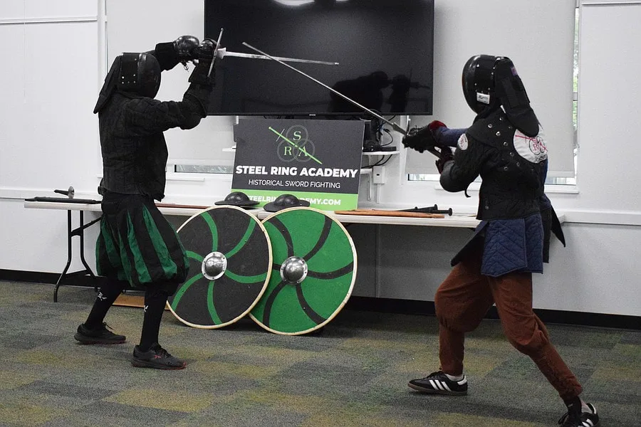 Chris and Galloway demonstrate a longsword fight during a summer reading program demonstration